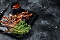 Chinese food dip fried duck tongue Black background. Top view. Copy space Royalty Free Stock Photo