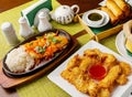 Chinese food, multi-course dinner in plates on the table Royalty Free Stock Photo