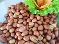 Chinese food style, Top view of deep fried peanuts with lettuce and carrot in white plate. Royalty Free Stock Photo