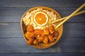 Chinese Food Sweet and Sour, Orange or Lemon Chicken with rice in wooden bowl on rustic table Royalty Free Stock Photo