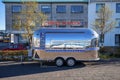 Chinese food trailer parked against building on street during sunny day