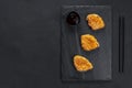 Chinese fried chicken nuggets in batter on a black background. Asian cuisine. Tahu nuggets or tofu, Indonesian food, a Royalty Free Stock Photo