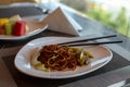 Chinese fried noodles and chopsticks. Side dish of celery and carrots. Chinese cabbage. Brown chinese spaghetti with