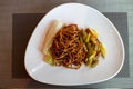 Chinese fried noodles. Side dish of celery and carrots. Chinese cabbage. Brown chinese spaghetti with vegetables.