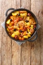 Chinese Galinha a Portuguesa chicken stew with vegetables in coconut curry close-up in a frying pan. Vertical top view Royalty Free Stock Photo