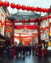 London, UK/Europe; 20/12/2019: Chinese gate and red lanterns in Chinatown in the district of Soho, London. People walking and