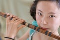 Chinese Girl Blowing Bamboo Flute