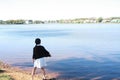 Chinese girl child throwing stone in the water