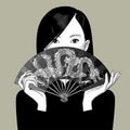 Chinese girl girl covers her face with a fan with a dragon Royalty Free Stock Photo