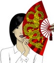 Chinese girl girl covers her face with a fan with a dragon Royalty Free Stock Photo