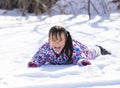 Chinese Girl lying in the snow Royalty Free Stock Photo