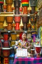 A chinese girl playing the djembe in the retail which is located at the Old Town of Lijiang in Yunnan Province, China. Royalty Free Stock Photo