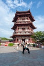 Chinese girl playing in front of a pagoda in Xi`an Tang paradise park