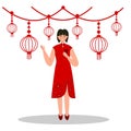 Chinese girl in red dress holding red envelope or ang pao angpao to celebrate chinese new year