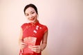 Chinese girl in traditional dress cheongsam holding red packets Woman hold with lucky money