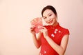 Chinese girl in traditional dress cheongsam holding red packets Woman hold with lucky money