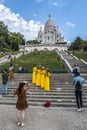 Chinese girls in traditional dresses in Paris with the Montmartre Basilica in the background