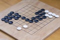 Chinese go game board, close up view of playing black and white stone pieces