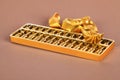 Chinese gold ingot and golden abacus Royalty Free Stock Photo