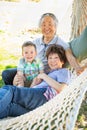 Chinese Grandparents In Hammock with Mixed Race Baby