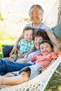 Chinese Grandparents In Hammock with Mixed Race Children