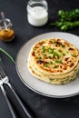 Chinese green onion pancakes on a black background. Stack of fried green onion pancakes. Dark photo Royalty Free Stock Photo