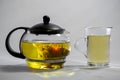 Chinese green tea Bud blooms in a glass teapot. Cup of tea on white background Royalty Free Stock Photo