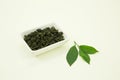 Chinese green tea. Milk Oolong Tea. Lemon leaf. Isolated in a white bowl on a white background