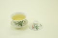 Chinese green tea. Milk Oolong Tea. Green tea in a beautiful traditional oriental cup with saucer. Isolated on a white background Royalty Free Stock Photo