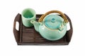 Chinese green teapot and teacups on the wooden trivet isolated Royalty Free Stock Photo