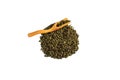 Chinese green teguanin tea, scattered on a white background, poured with a tea spatula and a tea filter.