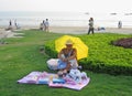 Chinese hawker selling toy items on the beach