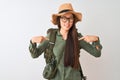 Chinese hiker woman wearing canteen hat glasses backpack over isolated white background looking confident with smile on face, Royalty Free Stock Photo