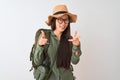 Chinese hiker woman wearing canteen hat glasses backpack over isolated white background pointing fingers to camera with happy and Royalty Free Stock Photo