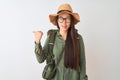 Chinese hiker woman wearing canteen hat glasses backpack over isolated white background smiling with happy face looking and Royalty Free Stock Photo