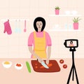 Chinese Japanese Female chef cooking in the kitchen while recording video using her camera for her online video channel. Cook