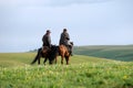 Chinese Kazakh herdsmen riding horse in grassland Royalty Free Stock Photo