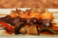 Chinese kebab on a white plate in Asian restaurant Royalty Free Stock Photo