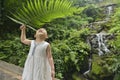 Chinese kid holding green fern above head Royalty Free Stock Photo