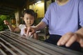 Chinese kid learning to play with traditional musical instrument