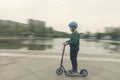 Chinese kid riding scooter