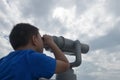 Chinese kid using telescope lookout Royalty Free Stock Photo