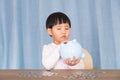 Chinese kids are tossing the piggy bank to see if there are coins