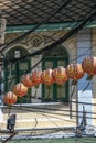 Chinese lanterns in the electric cables across the street. Travel around Asia.