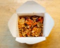 chinese leftovers in a take out box