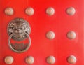 Chinese lion head door knocker on red door Royalty Free Stock Photo