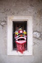 Chinese lion mask in the cement window wall. Royalty Free Stock Photo