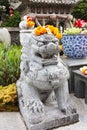 Chinese Lion Stone Statue with Marigolds garlands on head Royalty Free Stock Photo
