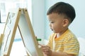 Chinese little boy coloring with crayon Royalty Free Stock Photo