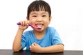 Chinese little girl brushing teeth